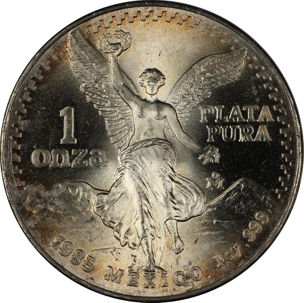 1982 - 1995 Mexico 1 Troy Oz .999 Fine Silver Libertad Silver Coin I Features the National Seal of Mexico 'Estados Unidos Mexicanos' Winged Victory Statue With Volcanoes Popocatépetl and Iztaccíhuatl I Monetized By Mexican Government